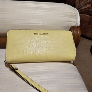 Yellow Michael Kors tech wallet.